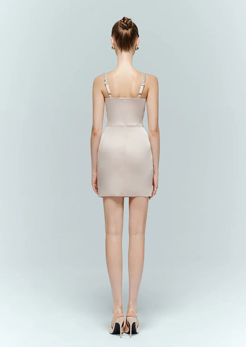 Back view of the light pink bodycon dress, showing the tailored fit, straight back cut, and delicate crystal shoulder straps