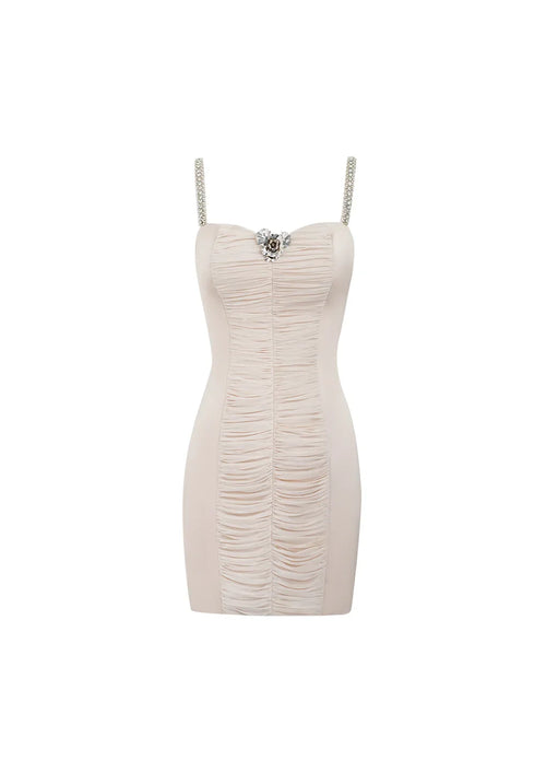 Product-only front view of the ruched bodycon dress in pink, showing the unworn garment's structural shape and central flower embellishment
