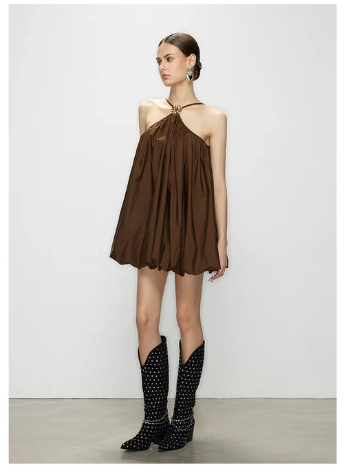 Full side profile of model wearing Élan halter mini dress with bubble hem and relaxed trapeze silhouette, showing the flow and bubble finish.