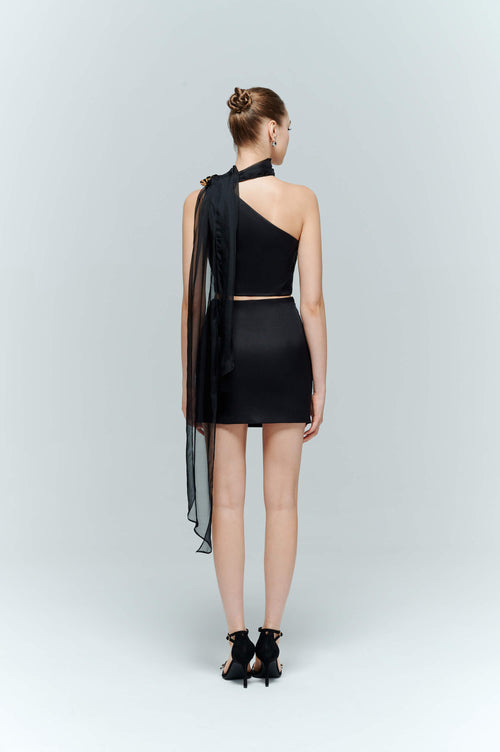 Back view of the Seraphine black satin top paired with the Onyx skirt, showing the discreet closure and sleek silhouette.