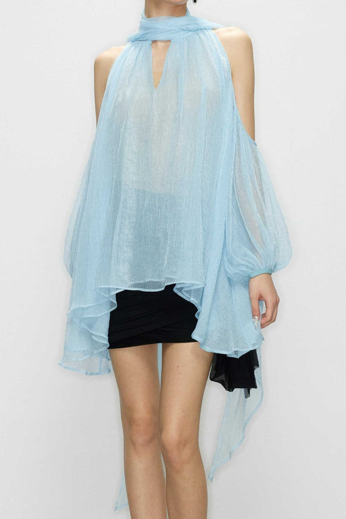 Close-up of the ultra-lightweight blue tulle fabric and three-dimensional bias tailoring on the Aurorette cold shoulder blouse.