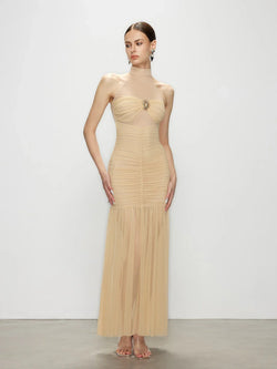 Front view of the Celestia champagne halter maxi dress, featuring an elegant ruched bodice and a flattering bodycon dress silhouette