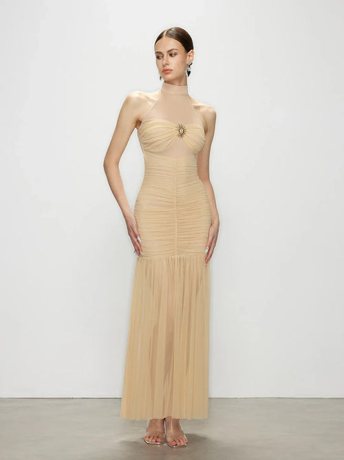 Front view of the Celestia champagne halter maxi dress, featuring an elegant ruched bodice and a flattering bodycon dress silhouette