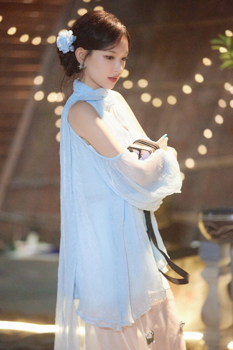 Celebrity Cheng Xiao wearing the Artel Retro Aurorette light blue tulle cold shoulder blouse, styled with a sheer summer drape