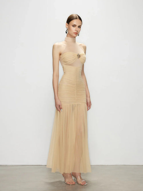 Studio shot of the Celestia ruched dress in beige, highlighting the flattering tailored fit that stands out among premium bodycon dresses