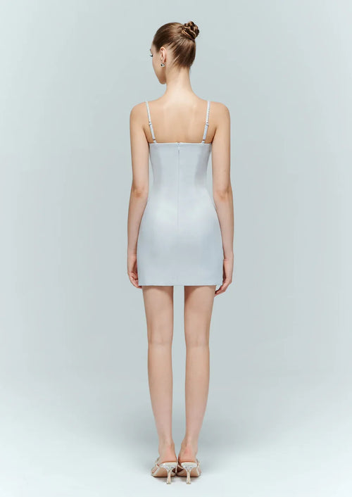 Back view of the minimalist light blue evening dress, showcasing the structured fit and sparkling crystal straps.