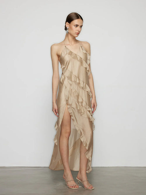 Front view of the minimalist elegant cascading ruffle dress in beige, showing the tailored bodice and floating ribbon details.