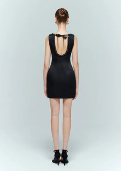 Full back view of the black backless dress featuring an elegant tie back design