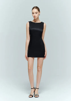 Front view of model wearing the minimalist backless black bodycon dress