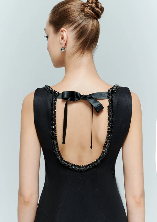 Close up detail of the open back and adjustable bow on the tie back dress