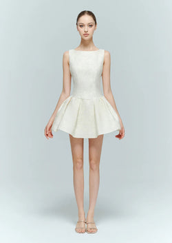 Model in Selene cream white embellished mini dress, a structured fit-and-flare bridal shower outfit.