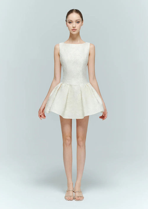 Model in Selene cream white embellished mini dress, a structured fit-and-flare bridal shower outfit.