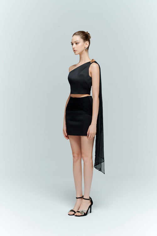 Side profile of the Seraphine black crop top, demonstrating the elegant length of the cascading floor-sweeping silk train.