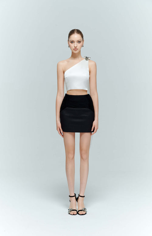 Full body front view of the model styling the Seraphine white crop top, displaying the bold, modern lines and lustrous satin fabric.