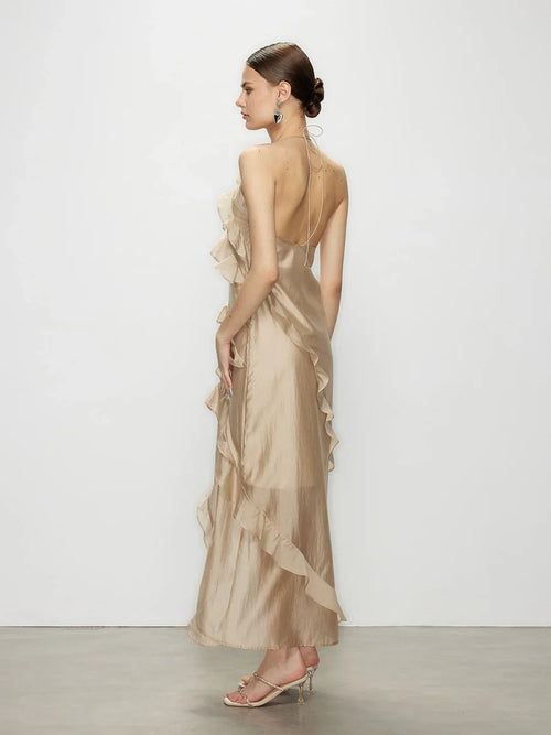 Back and side view of the Wavekiss beige ruffle maxi dress, emphasizing the sweeping silhouette and open back.