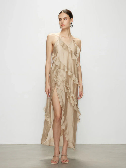 Model wearing the sleeveless Wavekiss beige ruffle maxi dress, a minimalist elegant dress featuring an asymmetrical high slit.