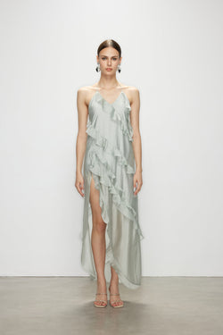 Model wearing the sleeveless Wavekiss light blue ruffle dress, a minimalist elegant high slit dress featuring cascading sheer details.