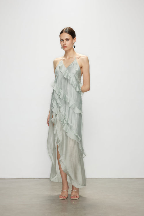 Model in the sleeveless Wavekiss light blue ruffle dress, capturing the understated luxury and clean lines of this elevated design.
