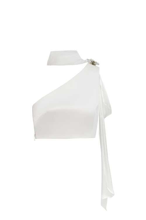 Front view of the Seraphine white crop top garment without a model, featuring the architectural asymmetrical cut and silver hardware.